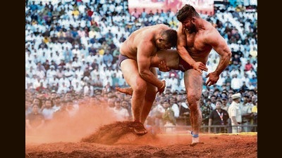 Mahendra Gaikwad (lefr) from Solapur and Sikandar Shaikh from Washim in action during sand category wrestling final in Pune. (Pratham Gokhale/HT Photo) Mahendra Gaikwad (lefr) from Solapur and Sikandar Shaikh from Washim in action during sand category wrestling final in Pune. (Pratham Gokhale/HT Photo)