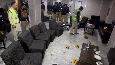 Police officials inspect the site after a leading lawyer was murdered in a break room at Peshawar High Court in Peshawar. (AFP)