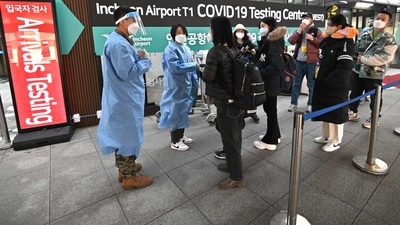 Health workers guide travellers arriving from China in front of a Covid-19 testing centre at Incheon International Airport, west of Seoul on January 3. (AFP) Health workers guide travellers arriving from China in front of a Covid-19 testing centre at Incheon International Airport, west of Seoul on January 3. (AFP)