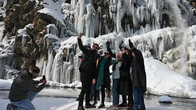 Tourists posing for photographs near a frozen waterfall in the Drang area of Tangmarg, north of Srinagar, Kashmir. (Waseem Andrabi /HT) Tourists posing for photographs near a frozen waterfall in the Drang area of Tangmarg, north of Srinagar, Kashmir. (Waseem Andrabi /HT)