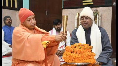 Uttar Pradesh chief minister Yogi Adityanath performs ‘abhishek’ of Lord Shiva, in Gorakhpur Monday. (PTI Photo)