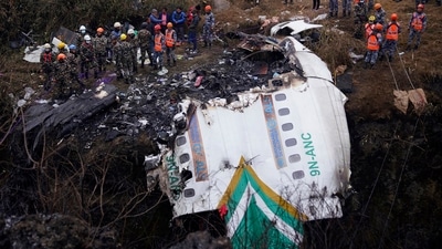 Rescuers scour the crash site in the wreckage of a passenger plane in Pokhara, Nepal, Monday, Jan.16, 2023. (AP) Rescuers scour the crash site in the wreckage of a passenger plane in Pokhara, Nepal, Monday, Jan.16, 2023. (AP)