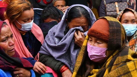 Family members and relatives of victims who died in a Yeti Airlines plane crash, weep outside a hospital in Pokhara.(AFP)