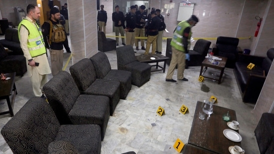 Police officials inspect the site after a leading lawyer was murdered in a break room at Peshawar High Court in Peshawar. (AFP)