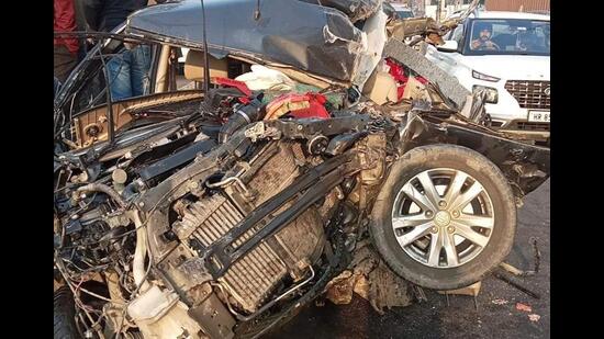 The mangled remains of the car that rammed into a parked stationary truck reportedly due to fog on the Ambala-Jagadhri highway on Monday. (HT Photo)