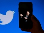 Taliban On Twitter: Phone screen displays a photo of Elon Musk with the Twitter logo. Taliban On Twitter: Phone screen displays a photo of Elon Musk with the Twitter logo.