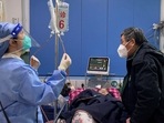 World Health Organisation On Covid: A medical worker checks the IV drip treatment of a patient lying on a bed in the emergency department of a hospital, amid the coronavirus disease (COVID-19) outbreak in Shanghai, China.