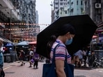 Covid In Hong Kong: A woman uses an umbrella to shield herself from the sun in Hong Kong.(AFP) Covid In Hong Kong: A woman uses an umbrella to shield herself from the sun in Hong Kong.(AFP)