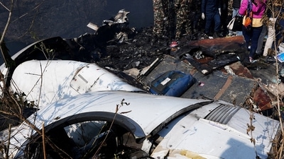 Nepal Plane Crash: Rescue teams work to retrieve bodies from the wreckage at the crash site. (Reuters)