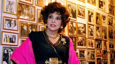Gina Lollobrigida Death: Italian film icon Gina Lollobrigida poses near a wall of celebrity photos in her villa in southern Rome. (File)