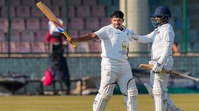 Sarfaraz Khan celebrates his century with teammate Shams Mulani (PTI) Sarfaraz Khan celebrates his century with teammate Shams Mulani (PTI)