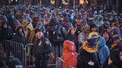 Revellers gather under the rain during the New Year's Eve celebrations in Times Square, New York, US. (AP) Revellers gather under the rain during the New Year's Eve celebrations in Times Square, New York, US. (AP)