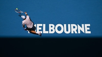 Austria's Dominic Thiem hits a return against Russia's Andrey Rublev during their men's singles match on day two of the Australian Open tennis tournament in Melbourne on January 17, 2023. (Photo by ANTHONY WALLACE / AFP) / -- IMAGE RESTRICTED TO EDITORIAL USE - STRICTLY NO COMMERCIAL USE -- (AFP) Austria's Dominic Thiem hits a return against Russia's Andrey Rublev during their men's singles match on day two of the Australian Open tennis tournament in Melbourne on January 17, 2023. (Photo by ANTHONY WALLACE / AFP) / -- IMAGE RESTRICTED TO EDITORIAL USE - STRICTLY NO COMMERCIAL USE -- (AFP)