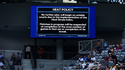 Australian Open 2023: Heat policy message is displayed on the big screen as play is suspended on the outside courts due to high temperatures. (REUTERS)