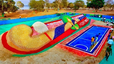 Odisha: Sand artist Sudarsan Pattnaik creates a '105 feet Hockey stick with 5000 Hockey ball' sand sculpture near Barabati Stadium in Mahanadi, Cuttack (PTI) Odisha: Sand artist Sudarsan Pattnaik creates a '105 feet Hockey stick with 5000 Hockey ball' sand sculpture near Barabati Stadium in Mahanadi, Cuttack (PTI)