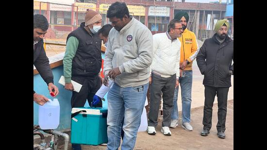 A team formed by the state government collecting water samples from the Zira Liquor Factory. (HT photo)