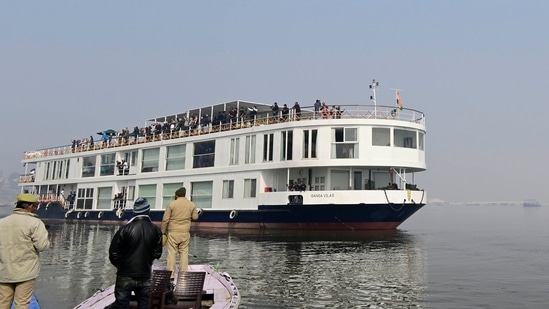 Policemen watch the MV Ganga Vilas set sail on the River Ganges after it was flagged-off remotely by Indian prime minister Narendra Modi, in Varanasi, India, Friday, Jan. 13, 2023.