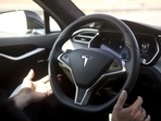 Autopilot features are demonstrated in a Tesla Model S.