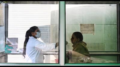 A health worker collects a swab sample for Covid-19 test at the District Hospital in Sector 30 in Noida on December 31. (Sunil Ghosh/HT Photo) A health worker collects a swab sample for Covid-19 test at the District Hospital in Sector 30 in Noida on December 31. (Sunil Ghosh/HT Photo)