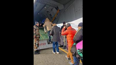 Civilians boarding an IAF aircraft in Srinagar on Wednesday. (HT Photo)