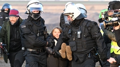 Greta Thunberg Germany Protests: Police officers carry Swedish climate activist Greta Thunberg. (AFP) Greta Thunberg Germany Protests: Police officers carry Swedish climate activist Greta Thunberg. (AFP)