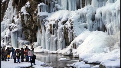 Tourists visit a frozen waterfall at Drung area of Tangmarg in Baramulla district of north Kashmir on Wednesday. (PTI) Tourists visit a frozen waterfall at Drung area of Tangmarg in Baramulla district of north Kashmir on Wednesday. (PTI)