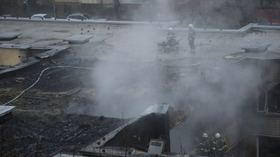 The crash site can be seen covered in flames and smoke as rescue operations are carried out. (REUTERS)