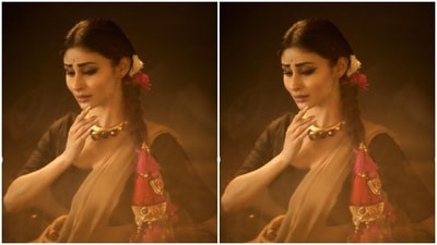 Mouni wore her tresses in a clean braid and added rose and flowers to her hair. She also added more ethnic vibes to her look with pink pompom and golden zari details to her braid. (Instagram/@imouniroy) Mouni wore her tresses in a clean braid and added rose and flowers to her hair. She also added more ethnic vibes to her look with pink pompom and golden zari details to her braid. (Instagram/@imouniroy)