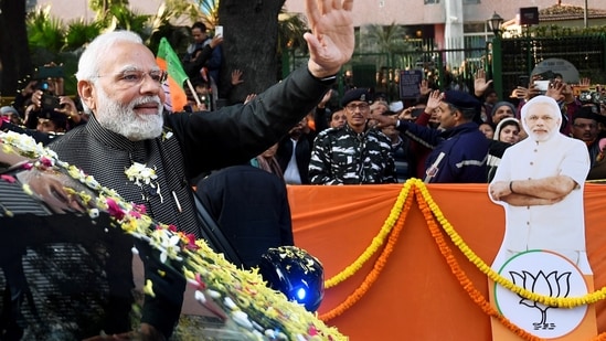 Prime Minister Narendra Modi waves to supporters during a roadshow from Patel Chowk to Parliament Street ahead of the BJP national executive meeting in New Delhi. (ANI photo) Prime Minister Narendra Modi waves to supporters during a roadshow from Patel Chowk to Parliament Street ahead of the BJP national executive meeting in New Delhi. (ANI photo)