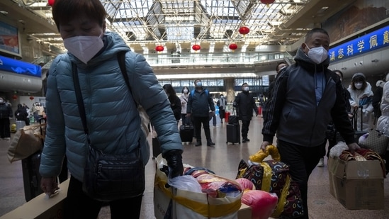 Lunar New Year China: Travelers walk along a concourse at Beijing West Railway Station in Beijing.(AP)