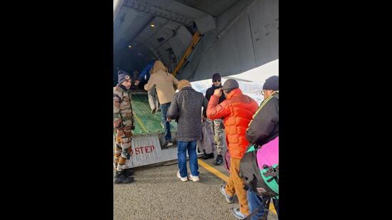 Civilians boarding an IAF aircraft in Srinagar on Wednesday. (HT Photo)