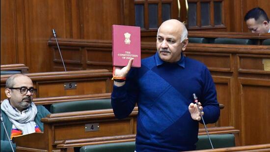 Manish Sisodia, holding a copy of the Constitution, said that if people believe in the Constitution, then they will have to agree that the municipal bodies and their matters are dealt by the state government, not by the Centre. (HT Photo)