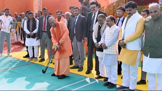 U.P. CM Yogi Adityanath wields a hockey stick at the Basti stadium. (Sourced)