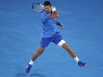 Novak Djokovic of Serbia plays a forehand return to Enzo Couacaud of France during their second round match at the Australian Open tennis championship in Melbourne, Australia, Thursday, Jan. 19, 2023. (AP) Novak Djokovic of Serbia plays a forehand return to Enzo Couacaud of France during their second round match at the Australian Open tennis championship in Melbourne, Australia, Thursday, Jan. 19, 2023. (AP)