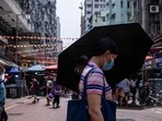 Covid In Hong Kong: A woman uses an umbrella to shield herself from the sun in Hong Kong.(AFP) Covid In Hong Kong: A woman uses an umbrella to shield herself from the sun in Hong Kong.(AFP)
