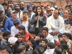 Wrestler Vinesh Phogat speaks during a 'dharna' to protest against the Wrestling Federation of India (WFI), at Jantar Mantar in Delhi, Thursday.