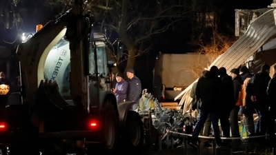 Ukraine Helicopter Crash: People work to retrieve the debris from a helicopter after it crashed, amid Russia's attack on Ukraine, in the town of Brovary, outside Kyiv, Ukraine. (Reuters)