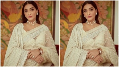 Sonam decked up in a pearl white saree featuring intricate work in silver zari borders, and silver sequin details in stripes. She teamed it with a white dupatta on one shoulder, featuring heavy embroidery work in white resham threads.&nbsp; (Instagram/@sonamkapoor)