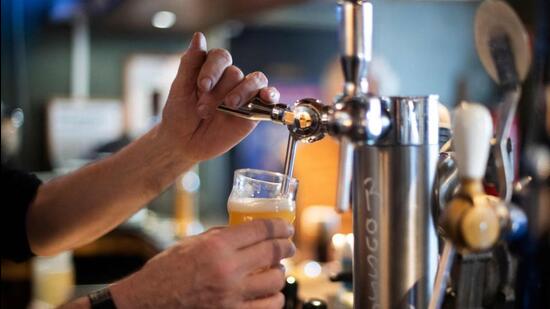 A bartender pours a daft beer in a bar in Brest, western France. (AFP)