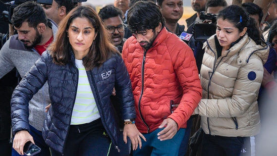 Wrestlers Vinesh Phogat, Sakshi Malik and Bajrang Punia arrive to sit on 'dharna' to protest against the Wrestling Federation of India (WFI), at Jantar Mantar in New Delhi on Thursday, (PTI)