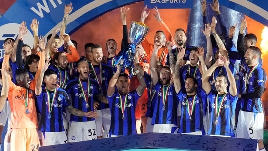 Inter Milan's Lautaro Martinez holds the trophy as he celebrates with his teammates after winning the Italian Super Cup final soccer match between AC Milan and Inter Milan at the King Saud University Stadium, in Riyadh, Saudi Arabia, Wednesday, Jan. 18, 2023. Inter Milan won 3-0. (AP Photo/Hussein Malla)(AP)