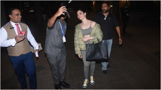 One of the pictures also showed Tamannaah clicking selfies with her fans before heading for her car.&nbsp;(HT Photo/Varinder Chawla)