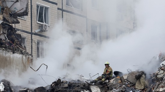 Russia-Ukraine War: An emergency personnel looks on at the site where an apartment block was heavily damaged by a Russian missile strike, amid Russia's attack on Ukraine, in Dnipro.(Reuters)