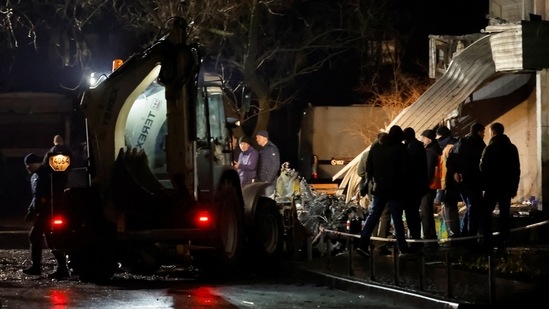 Ukraine Helicopter Crash: People work to retrieve the debris from a helicopter after it crashed, amid Russia's attack on Ukraine, in the town of Brovary, outside Kyiv, Ukraine.(Reuters)