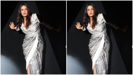 Neha decked up in the silver gown featuring intricate patterns in shades of black. It also came with collars, full sleeves, and a wrap detail below the waist, featuring a white feather pattern on one side.&nbsp;(Instagram/@nehadhupia)