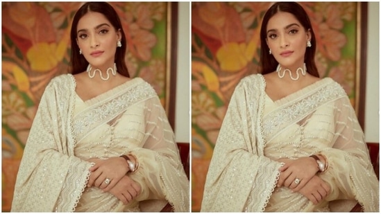 Sonam decked up in a pearl white saree featuring intricate work in silver zari borders, and silver sequin details in stripes. She teamed it with a white dupatta on one shoulder, featuring heavy embroidery work in white resham threads. (Instagram/@sonamkapoor)