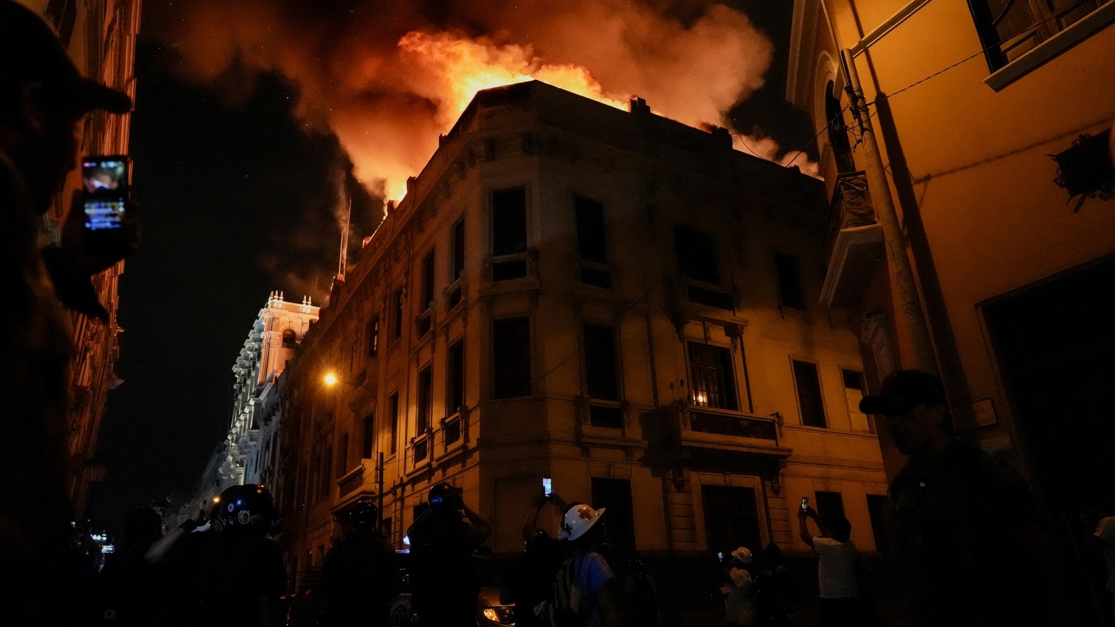 Thousands march on Peru's capital as unrest spreads, building set ablaze | Watch
