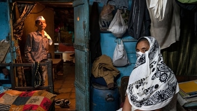 A commercial sex worker seen with Sunil Hajaran (back) at Alishan Building, Kamathipura, on January 6. Hajaran rents out the mezzanine floor of his house, where his mother was formally registered as a tenant, to sex workers. This is his only source of income. “I won’t be able to get anything from the redevelopment if I am unable to get my name registered as tenant,” he told HT. &nbsp;&nbsp; (Satish Bate / HT Photo)