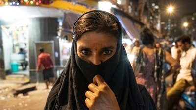 A commercial sex worker seen in the by-lanes of Kamathipura, where the redevelopment project is expected to create 2.3 million square feet of land for free sale in the heart of south Mumbai. “I don’t know where I will go and what I will do if removed,” a 25-year-old sex worker told HT. Most of them live with four to six other workers and pay between  <span class='webrupee'>₹</span>5,500 to  <span class='webrupee'>₹</span>7,500 a month as rent, in addition to the cut of  <span class='webrupee'>₹</span>40-50 they have to give per customer, HT reported. &nbsp; (Satish Bate / HT Photo)