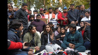 Wrestler Vinesh Phogat speaks to the media accusing the Wrestling Federation of India (WFI) president Brij Bhushan Sharan Singh of sexual harassment during a protest against Wrestling Federation of India, at Jantar Mantar, in New Delhi on Wednesday. Wrestlers Bajrang Punia and Sakshee Malikkh are also seen. (ANI)